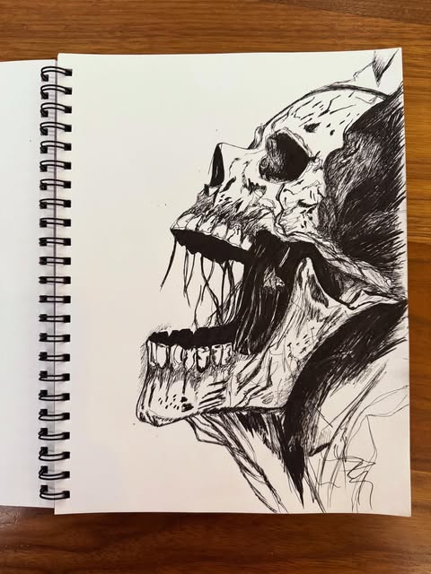 Ink drawing of a snarling skull-like creature with an open jaw